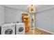 Laundry room with modern washer and dryer, unique light fixture and shelving at 2727 Easton Ter, Lakeland, FL 33803