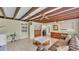 Living room with exposed beams and view into the dining room at 2727 Easton Ter, Lakeland, FL 33803