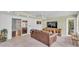 Bright living room with views, featuring tile floors, a ceiling fan and a wooden entertainment center at 2727 Easton Ter, Lakeland, FL 33803
