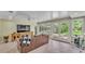 Spacious living room featuring tile floors, a ceiling fan and plentiful natural light at 2727 Easton Ter, Lakeland, FL 33803