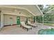 Outdoor pool and patio area featuring lounge chairs, ceiling fans, and access to lush greenery at 2727 Easton Ter, Lakeland, FL 33803