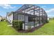 Wide shot of the home's screened in pool and lanai from the expansive lawn at 2772 Southland St, St Cloud, FL 34772