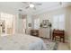 Bright bedroom featuring shuttered windows, a desk, and a dresser for ample storage at 2772 Southland St, St Cloud, FL 34772