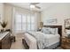 Bright bedroom featuring plantation shutters, neutral decor, and a comfortable bed with decorative pillows at 2772 Southland St, St Cloud, FL 34772