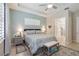 Charming bedroom with a tray ceiling, shuttered windows, and access to an ensuite bathroom at 2772 Southland St, St Cloud, FL 34772