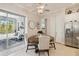 Bright breakfast nook with round table, upholstered chairs, and sliding doors to the screened lanai at 2772 Southland St, St Cloud, FL 34772