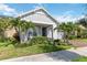 Attractive single-story house with palm trees, lush plants, and a brick driveway leading to a garage at 2772 Southland St, St Cloud, FL 34772