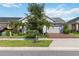 Charming single-story home with manicured landscaping, a brick driveway, and a two-car garage at 2772 Southland St, St Cloud, FL 34772