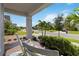 Cozy front porch featuring rocking chairs and a view of the landscaped front yard and neighborhood street at 2772 Southland St, St Cloud, FL 34772