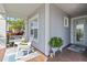 Relaxing front porch with brick floor, rocking chairs, swing and space to enjoy the outdoors at 2772 Southland St, St Cloud, FL 34772