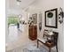 Hallway featuring tile floors with decorations along the wall and view of the living and kitchen area at 2772 Southland St, St Cloud, FL 34772