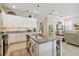 Bright kitchen with a granite island, stainless appliances, white cabinets, and pendant lighting at 2772 Southland St, St Cloud, FL 34772