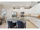 Spacious kitchen with white cabinets, a granite island with seating, and stainless steel appliances at 2772 Southland St, St Cloud, FL 34772