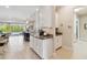 Modern kitchen with granite countertops, sleek cabinets, and an open view to the outdoor area at 2772 Southland St, St Cloud, FL 34772