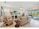 Cozy living room with fireplace, white shutters, tile flooring, and sliding glass doors to the pool at 2772 Southland St, St Cloud, FL 34772