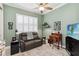 Inviting office space featuring a comfortable leather sofa, ceiling fan, and plantation shutters at 2772 Southland St, St Cloud, FL 34772