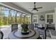 Relaxing covered patio features a sitting area, a ceiling fan and view of the pool at 2772 Southland St, St Cloud, FL 34772