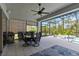 Covered patio features dining area, ceiling fan, outdoor kitchen, and screened pool and spa at 2772 Southland St, St Cloud, FL 34772