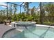 Enjoy the home's connecting pool and spa surrounded by tropical landscape at 2772 Southland St, St Cloud, FL 34772