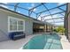 Backyard pool area featuring a screened-in patio, tiled deck, and well-maintained landscaping at 2772 Southland St, St Cloud, FL 34772
