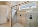 Elegant shower with a glass door, bench, and a convenient window for natural light at 2772 Southland St, St Cloud, FL 34772