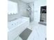 Spa-like bathroom with a soaking tub, glass-enclosed shower, and modern tile accents at 2805 Carter Grove Ln, Kissimmee, FL 34741