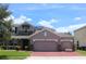 Charming two-story home with a brick driveway and stone accents, plus a three-car garage for ample parking at 2805 Carter Grove Ln, Kissimmee, FL 34741