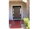 Close up of the front door with side windows, stone pillar, and brick paved walkway at 2805 Carter Grove Ln, Kissimmee, FL 34741