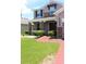 View of front door with side windows, stone pillars, and a brick paved walkway at 2805 Carter Grove Ln, Kissimmee, FL 34741
