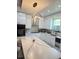 Stylish kitchen with modern appliances, sleek white cabinets, and an island with bar seating at 2805 Carter Grove Ln, Kissimmee, FL 34741