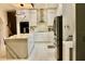Renovated kitchen featuring white cabinets, marble countertops, stainless steel appliances, and open layout at 2805 Carter Grove Ln, Kissimmee, FL 34741