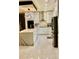 Bright and modern kitchen with white cabinets, marble countertops, island, and stainless steel appliances at 2805 Carter Grove Ln, Kissimmee, FL 34741