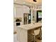 Modern kitchen with white cabinets, marble countertops, stainless steel appliances, and pendant lighting at 2805 Carter Grove Ln, Kissimmee, FL 34741