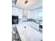Modern kitchen featuring white cabinets, stainless steel appliances, and a large island at 2805 Carter Grove Ln, Kissimmee, FL 34741