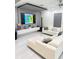 Modern living room with white tile floors, a large television, and contemporary decor at 2805 Carter Grove Ln, Kissimmee, FL 34741