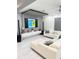Modern living room with white tile floors, a large television, and contemporary decor at 2805 Carter Grove Ln, Kissimmee, FL 34741
