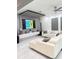 Modern living room with white tile floors, a large television, and contemporary decor at 2805 Carter Grove Ln, Kissimmee, FL 34741
