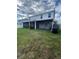 The backyard features a screened-in patio and a well-maintained lawn at 293 Fiddlewood Ct, Davenport, FL 33837