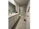 Bright bathroom with double vanity, glass-enclosed shower, and neutral decor at 293 Fiddlewood Ct, Davenport, FL 33837
