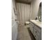 Neutral bathroom features a vanity, tile floor, toilet, and a shower with a curtain at 293 Fiddlewood Ct, Davenport, FL 33837