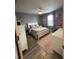 Inviting bedroom featuring soft gray walls, a ceiling fan, a window, and a white bed with gray bedding at 293 Fiddlewood Ct, Davenport, FL 33837