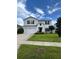 Charming two-story home with a well-manicured lawn and beautiful landscaping at 293 Fiddlewood Ct, Davenport, FL 33837