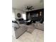 Stylish living room featuring neutral-toned sofas, dark accent wall, and modern ceiling fan at 293 Fiddlewood Ct, Davenport, FL 33837