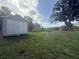 Backyard featuring a storage shed surrounded by a green grassy area at 3050 Old Soldier Rd, Lakeland, FL 33810