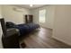 Bedroom featuring wood-look floors, neutral walls and a large window at 3050 Old Soldier Rd, Lakeland, FL 33810