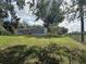 Exterior shot of home with a grassy yard and partial fencing at 3050 Old Soldier Rd, Lakeland, FL 33810