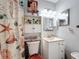 Cozy bathroom features a vanity with storage, and decorative shower curtain at 3158 Forest Breeze Way, St Cloud, FL 34771