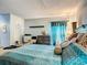 Comfortable bedroom featuring bright, patterned bedding and a window with stylish curtains at 3158 Forest Breeze Way, St Cloud, FL 34771