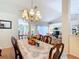 Elegant dining room features a chandelier, decor, and a view into the living room at 3158 Forest Breeze Way, St Cloud, FL 34771