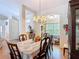 Dining room with natural lighting, an ornate chandelier, and a view into the living area at 3158 Forest Breeze Way, St Cloud, FL 34771